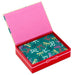 Open red box with pink interior containing a green card with colorful bow pattern on a white background