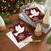 Decorative greeting cards with a dove design on a wooden surface with Christmas decorations.