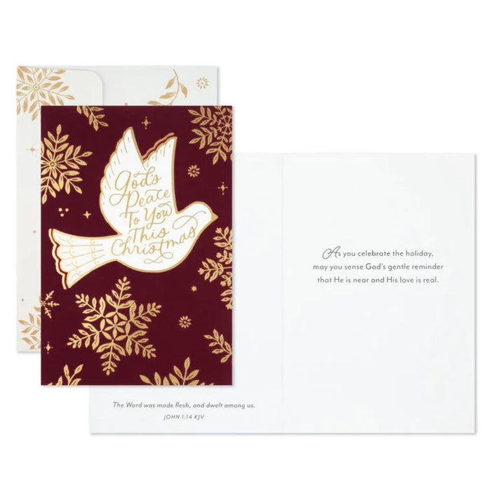Christmas card with gold dove and snowflakes on a red background