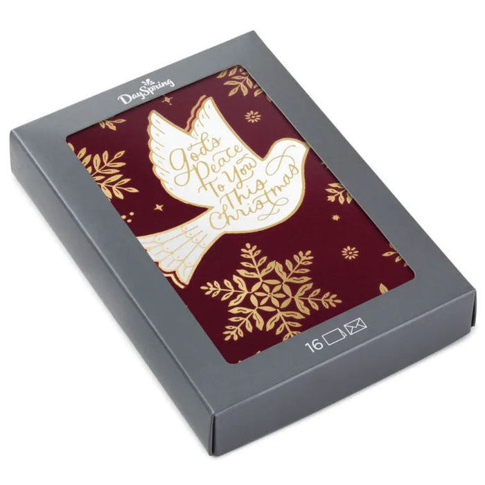 Box of Christmas cards with a dove and snowflake design on a red background