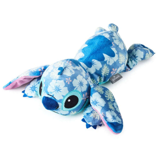 Plush toy Stitch with tropical floral pattern on a white background