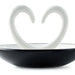  close up of Ring dish ceramic with arms that shape a heart. trinket dish on a white background. 