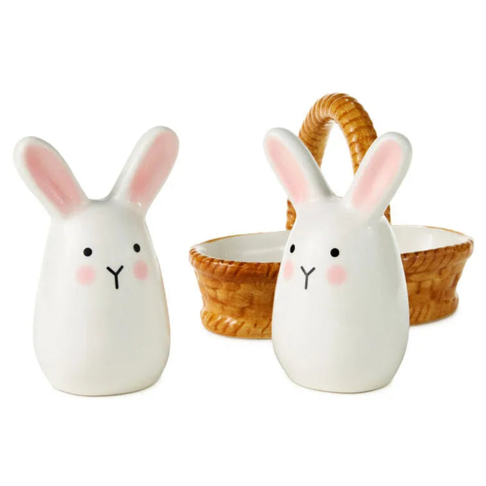 Two ceramic rabbit-shaped containers with a wicker basket on a white background
