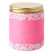 Pink candle with gold lid and decorative patterns on a white background