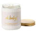 Candle jar labeled 'oh, baby!' with a gold lid on a white background
