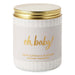Candle jar with 'oh, baby!' text and gold lid on a white background