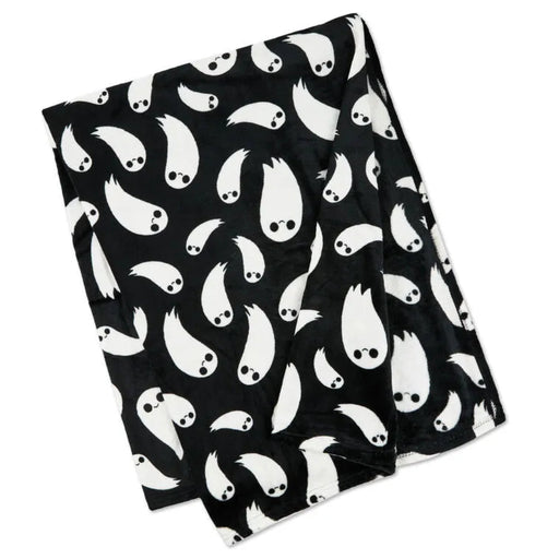 Black throw blacket with white ghost pattern on a white background