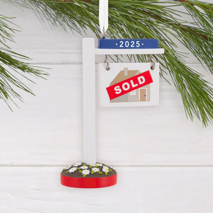 Decorative ornament with 'SOLD' sign and '2025' on a branch