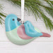 Decorative bird ornament with pastel colors on a white background