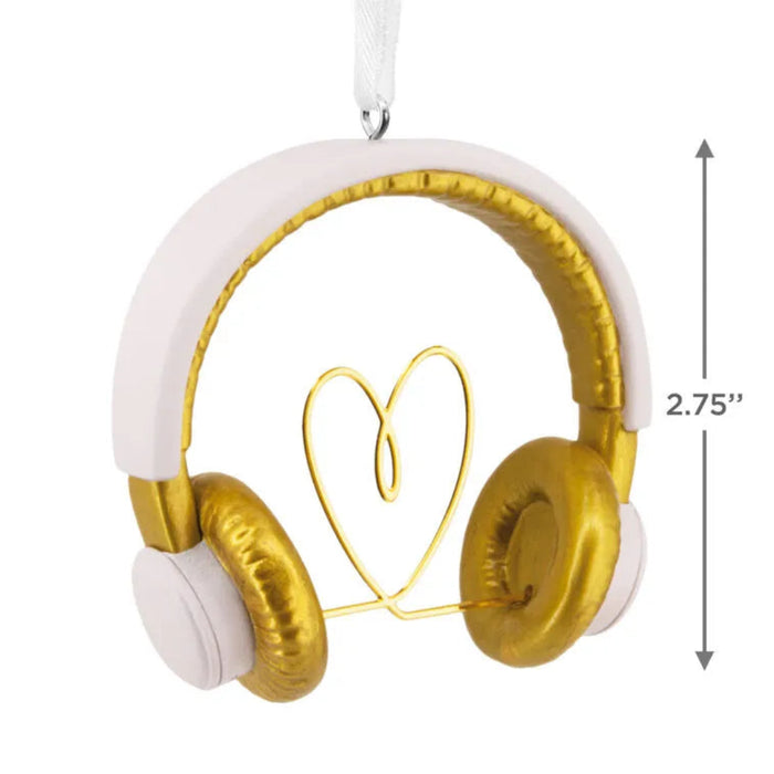 Gold and white headphones shaped like a heart with a measurement label on a white background