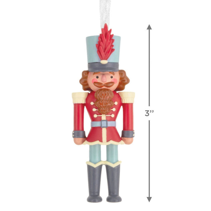 Decorative nutcracker ornament with measurement label on a white background