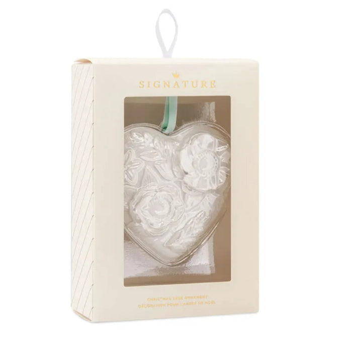 Heart-shaped glass ornament in a clear box with Hallmarks 'Signature' branding on a white background