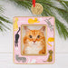 Cat-themed photo frame ornament with a pink border and cat illustrations on a white background.