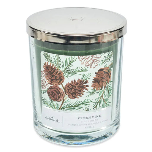 Hallmark 3 wick Glass candle with a silver lid and pine cone label on a white background