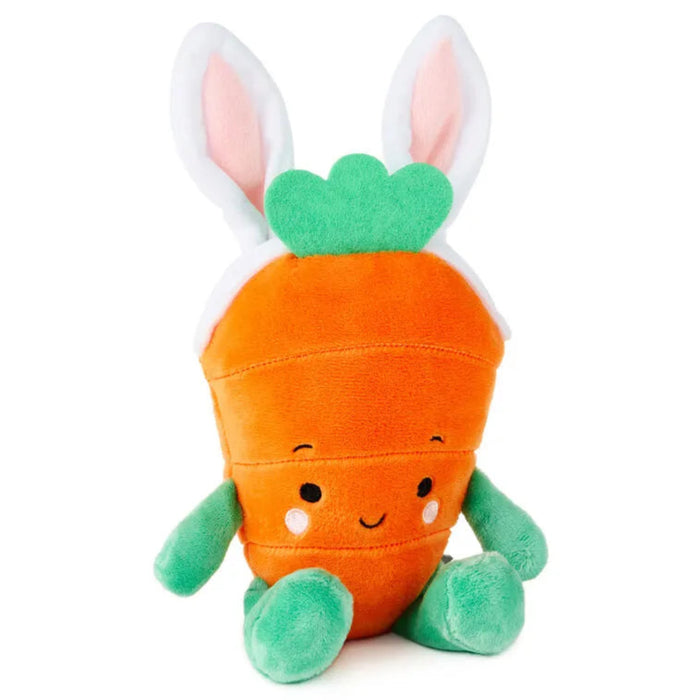 Plush toy carrot with bunny ears on a white background