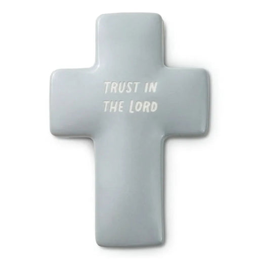 Gray cross-shaped object with 'Trust in the Lord' text on a white background