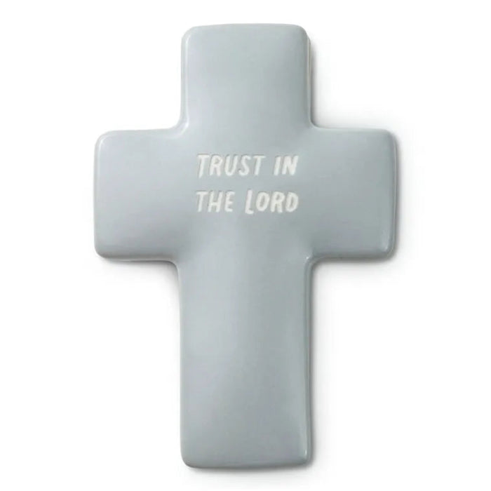 Gray cross-shaped object with 'Trust in the Lord' text on a white background