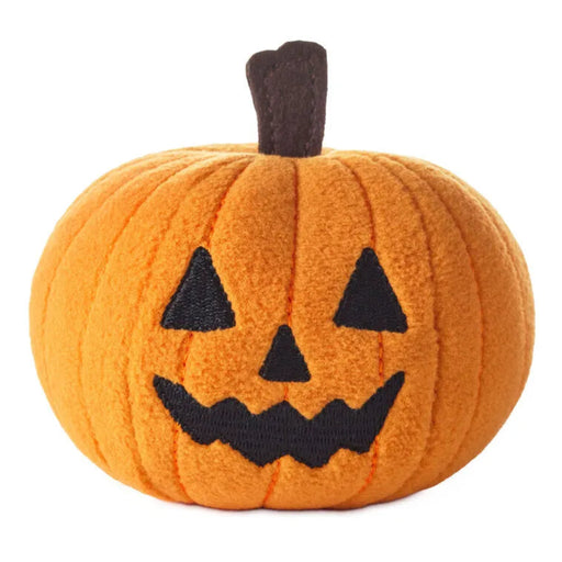 Plush pumpkin toy that zips along when you pull the back, it has a jack-o'-lantern face on a white background