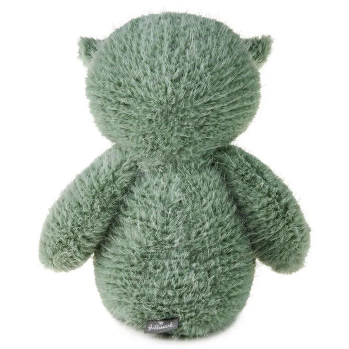Green plush toy on a white background