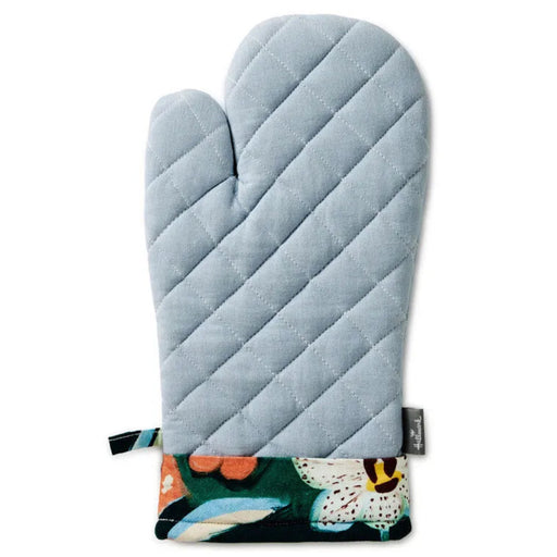 Light blue quilted oven mitt with floral pattern at the bottom on a white background