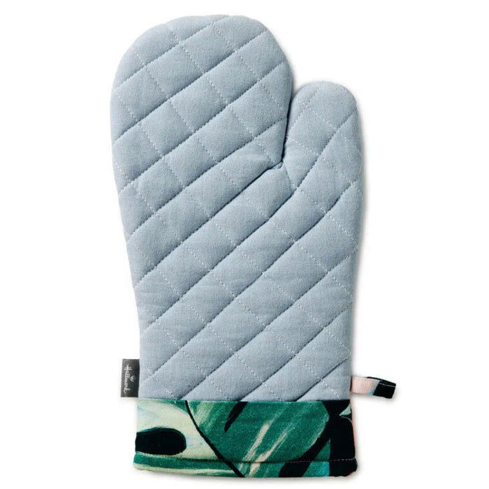 Light blue quilted oven mitt with a green leaf pattern at the bottom on a white background