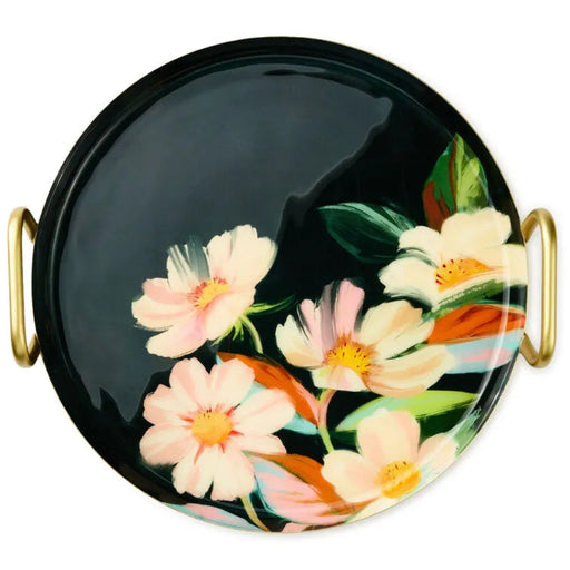 Round black tray with floral design and gold handles on a white background