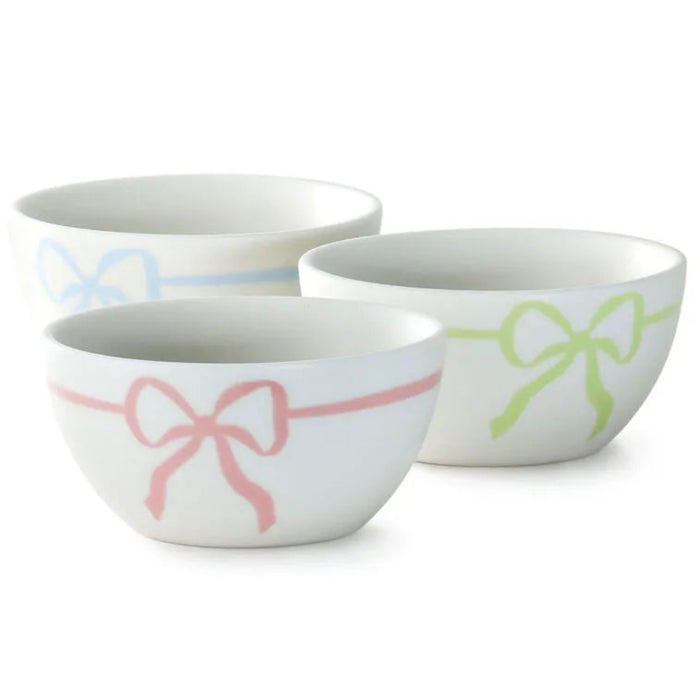 Set of four ceramic bowls with pastel color stripes on a white background