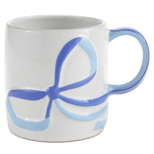 White mug with blue handle and abstract design on a white background