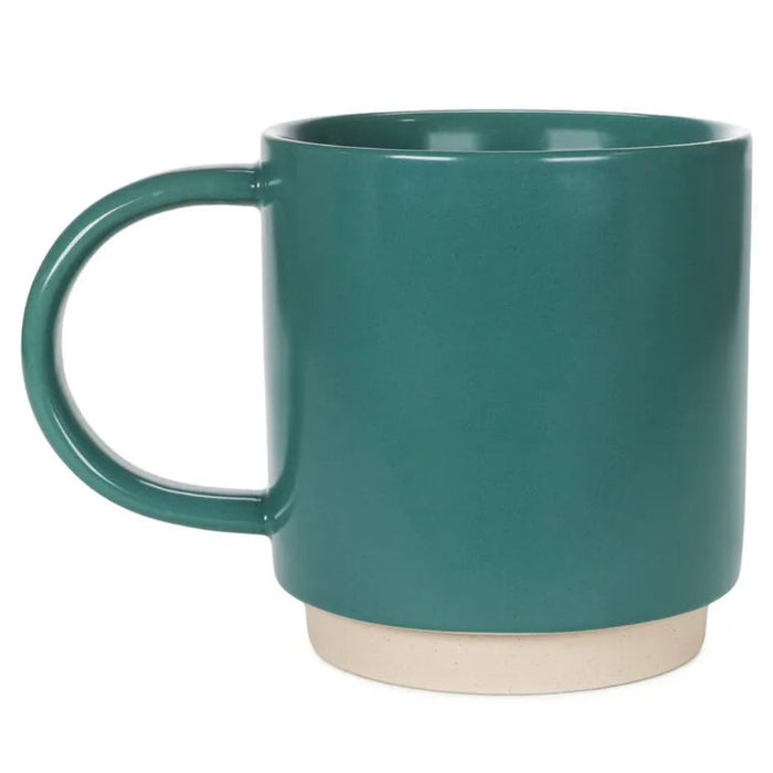 Teal mug with a ceramic  base on a white background