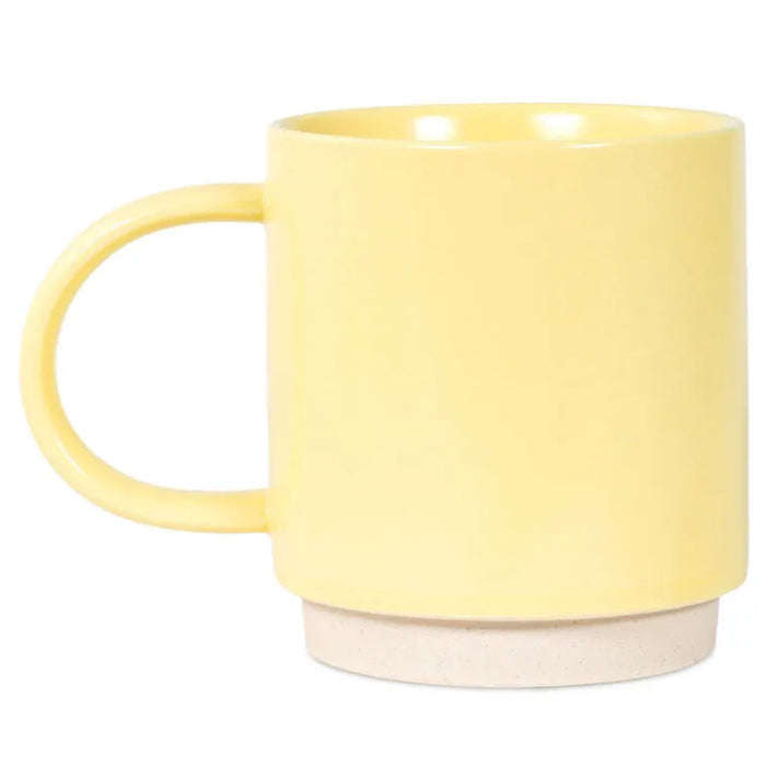Yellow mug with a white base on a white background