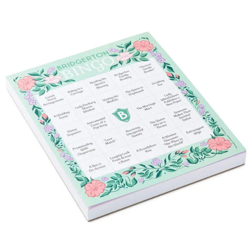 “Single Bridgerton bingo game pad with 102 tear-off sheets, shown at a slight angle to display thickness, featuring elegant floral artwork and a classic bingo grid on a white background.”