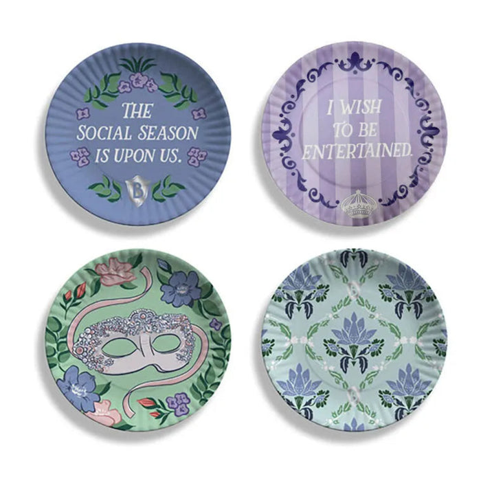 Four decorative plates with floral and text designs on a white background. A periwinkle plate with wisteria and a social season quote, a purple striped plate with scrollwork and witty text, a green plate showcasing a jeweled masquerade mask with florals, and an aqua plate with trellis-style florals. 
