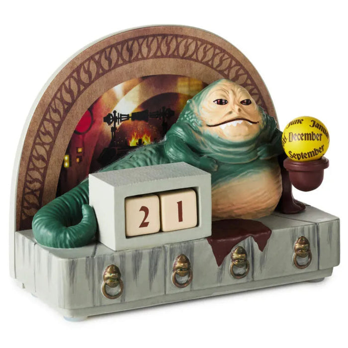 Decorative calendar with a green creature and wooden plaque on a white background