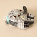 Plush toy resembling a robot or vehicle on a beige background