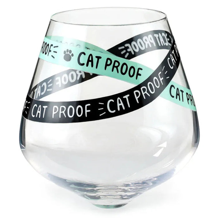 Clear glass with 'Cat Proof' tape wrapped around it on a white background
