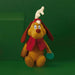 Plush toy dog May  with red scarf and an ornament  on green background