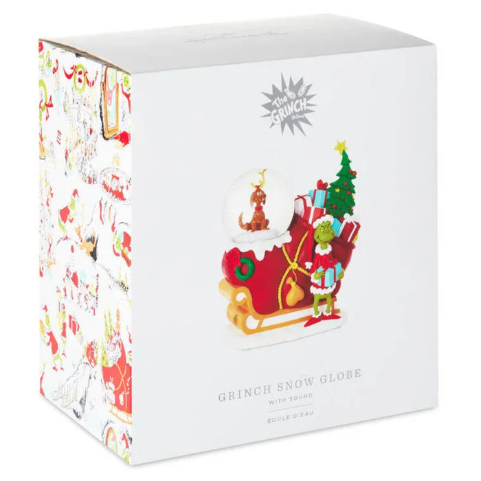 Boxed Grinch snow globe with sound featuring festive design.