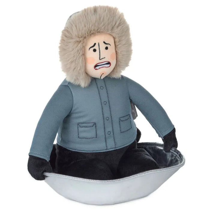 Stuffed toy resembling a person in winter clothing with a scared expression on a white background
