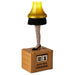 Decorative lamp with a leg, yellow shade, black skirt, fishnet stockings, and black shoes on a wooden block with '21 Days Till Christmas' display.