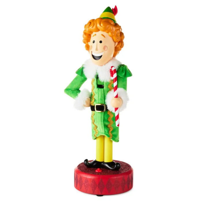 Christmas elf figurine Nutcracker holding a candy cane on a white background