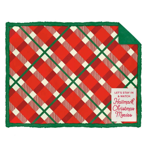 Red and green plaid blanket with a Hallmark Christmas Movies tag on a white background