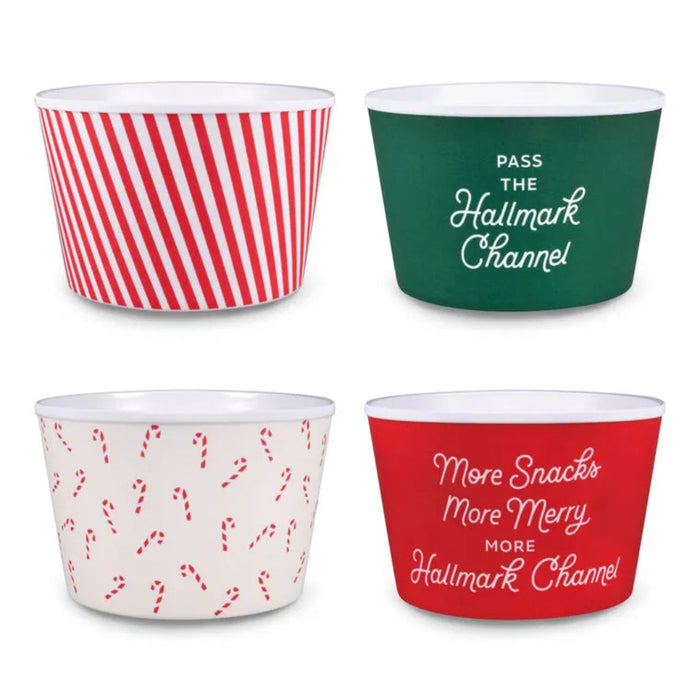 Four festive-themed popcorn bowls with holiday designs and text on a white background