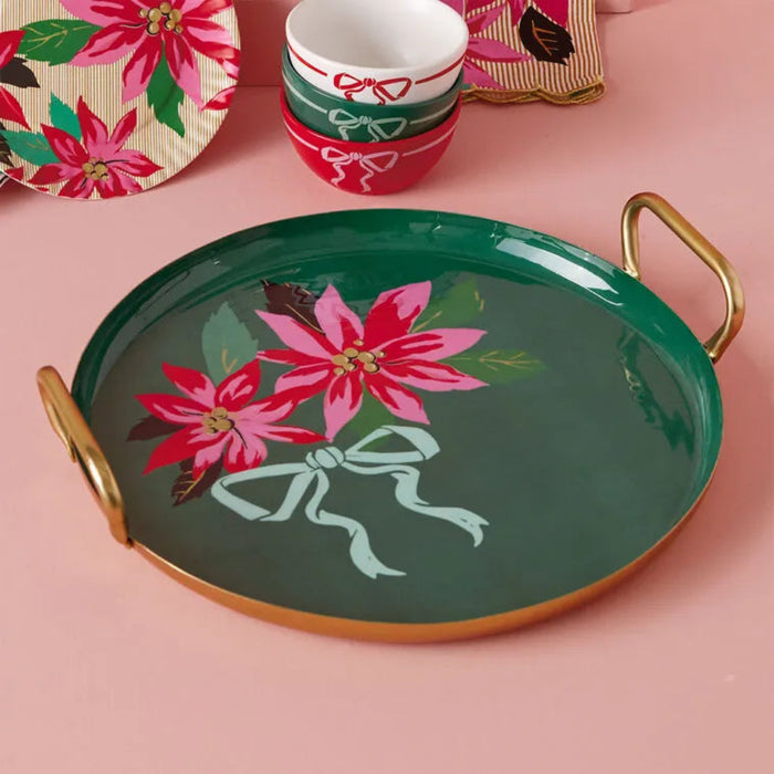 Decorative tray with poinsettia design on a pink surface