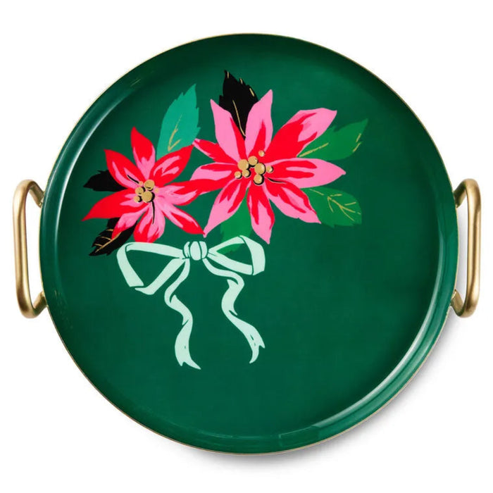 Green round tray with pink poinsettias and a green bow on a white background