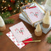 Peppermint themed Christmas cards on a wooden surface 