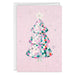 Greeting card with a colorful Christmas tree design on a pink background