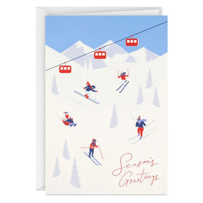 Greeting card with skiers and a ski lift against a mountain backdrop, featuring 'Season's Greetings' text.