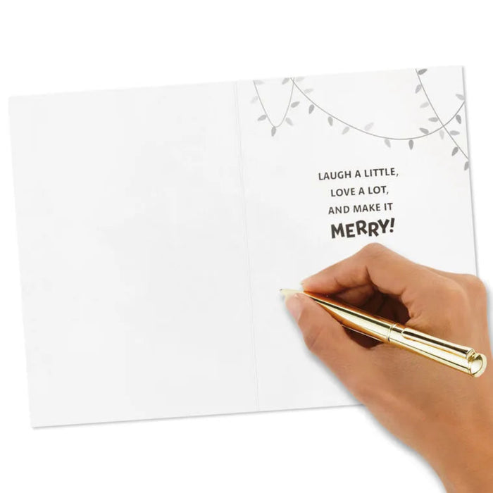 Hand holding a gold pen over a card with text on a white background