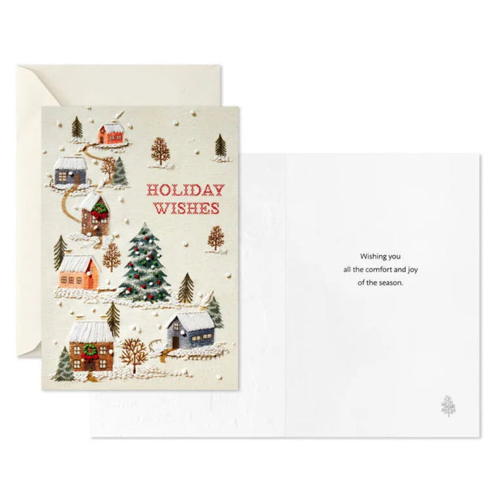 Christmas card with winter village scene and 'Holiday Wishes' text on a white background