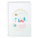 Christmas card with a snow globe design featuring trees and a house, on a white background.